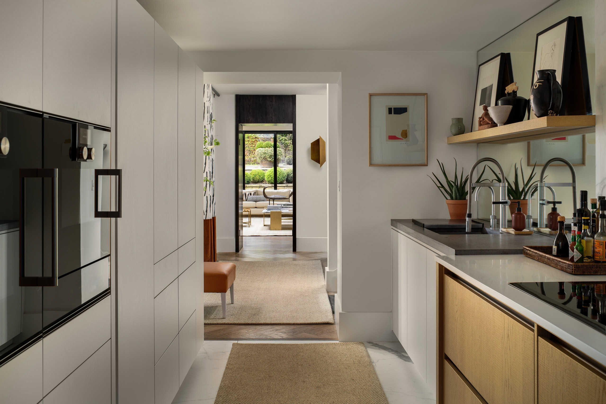 Modern kitchen with sleek white cabinetry and wooden accents, bright and inviting for contemporary l.