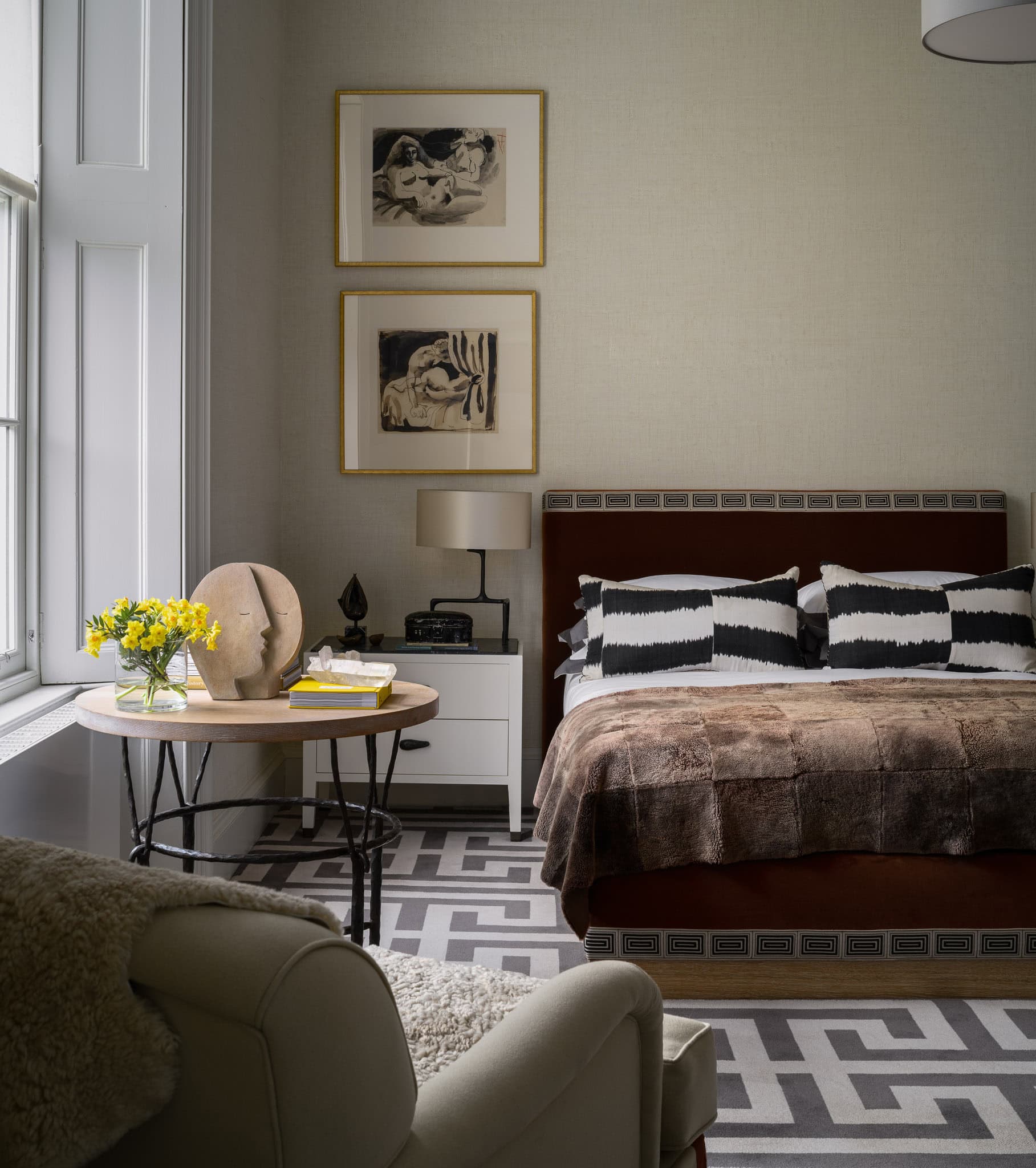 Relaxing bedroom with modern decor, black and white accents, and natural light from large window.