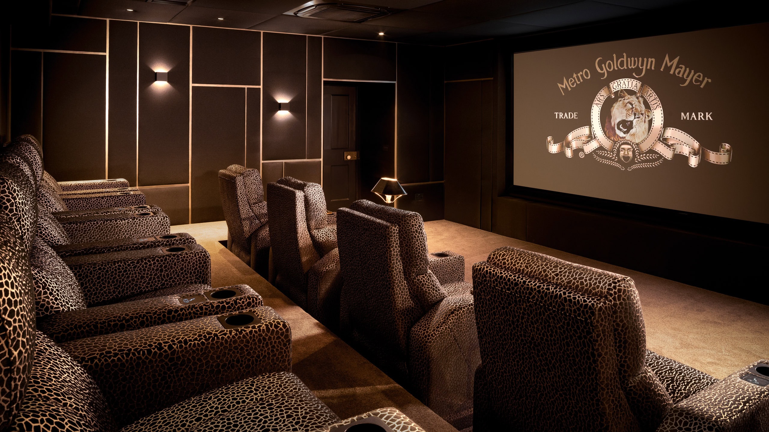 Luxurious home cinema room with plush seating and a large screen for an immersive movie experience.