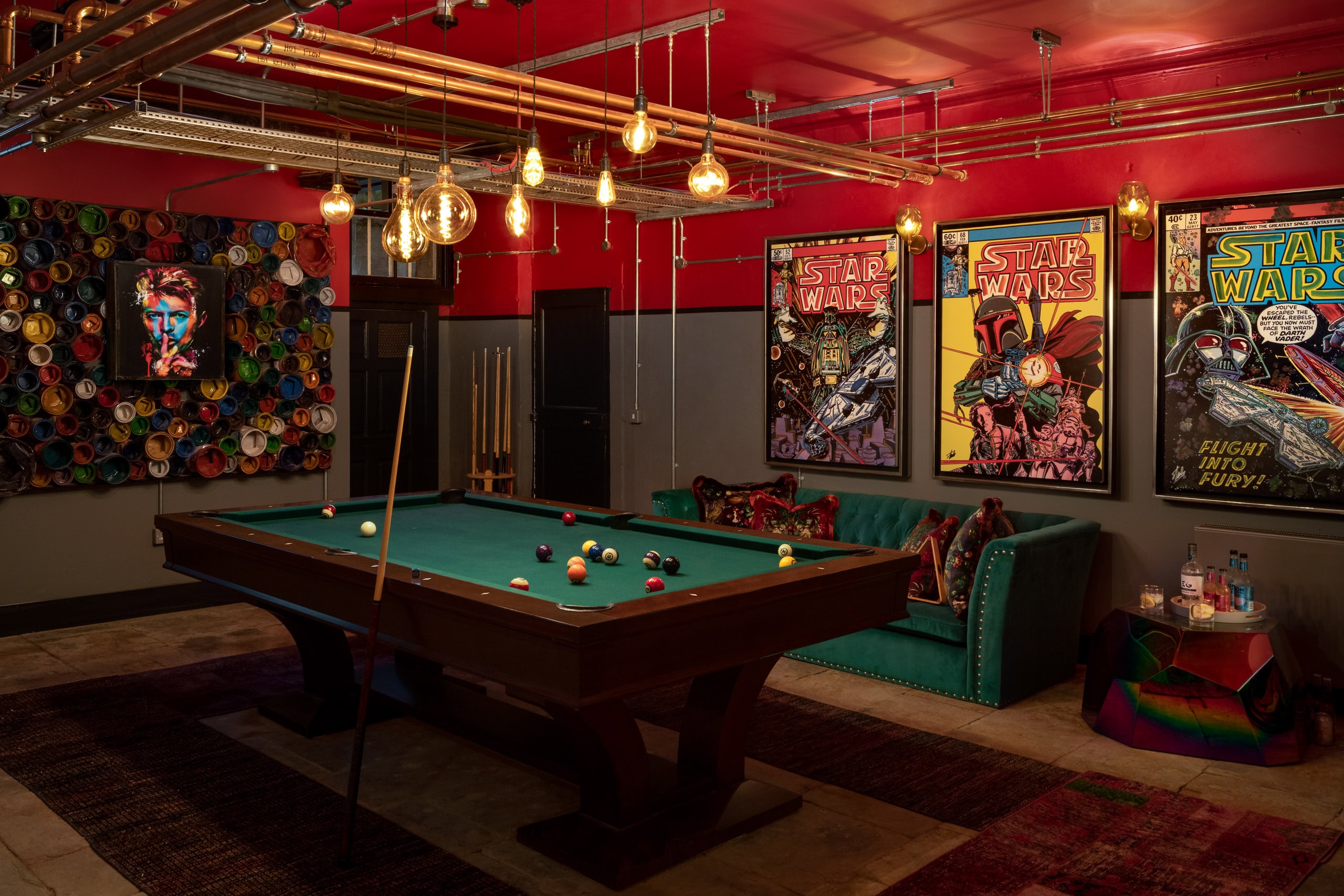 Pool table in a vibrant, Star Wars-themed entertainment room with colourful decor and artwork.