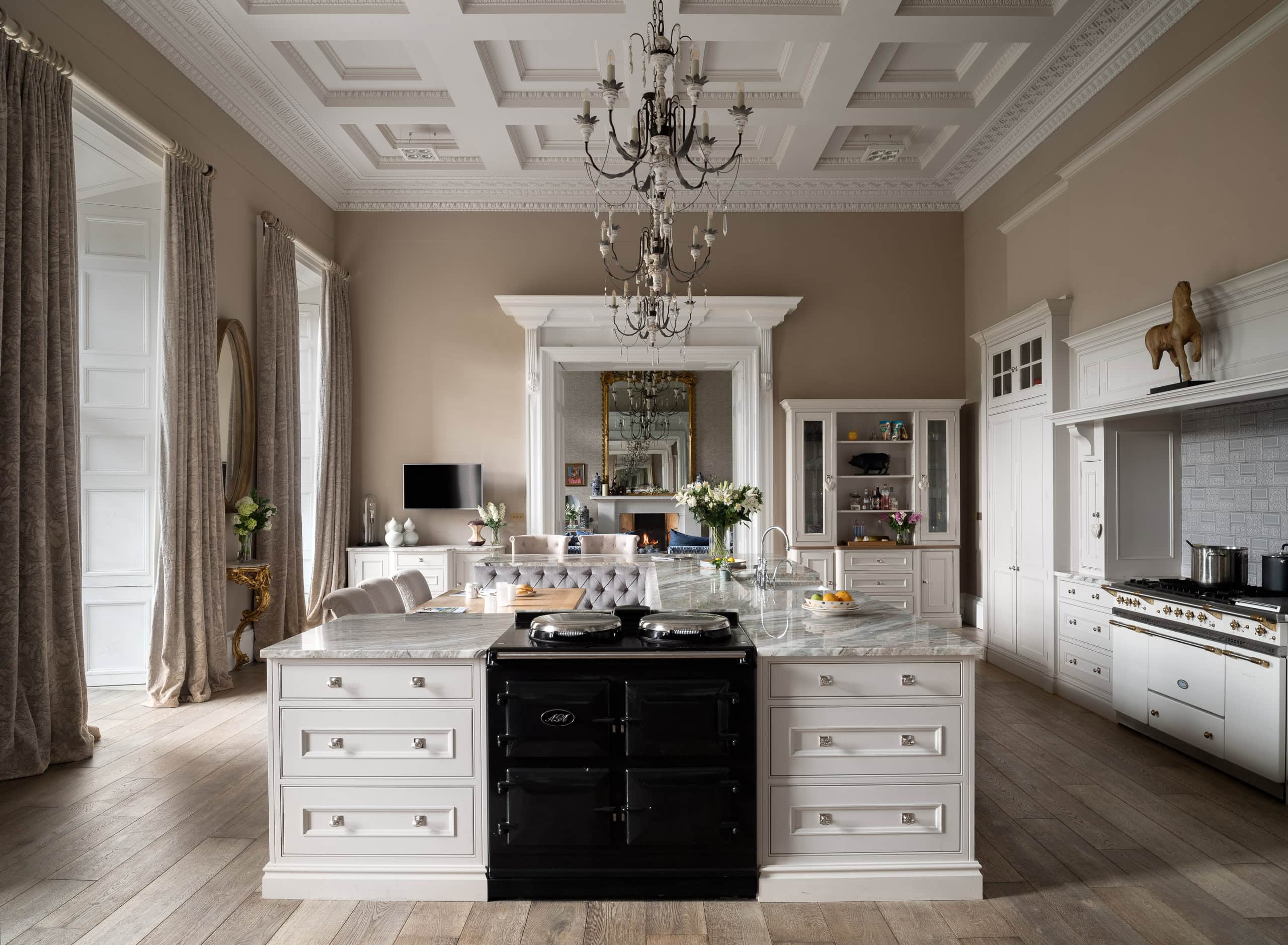 Elegant white kitchen with classic decor and central island, bright natural light, and vintage accen.