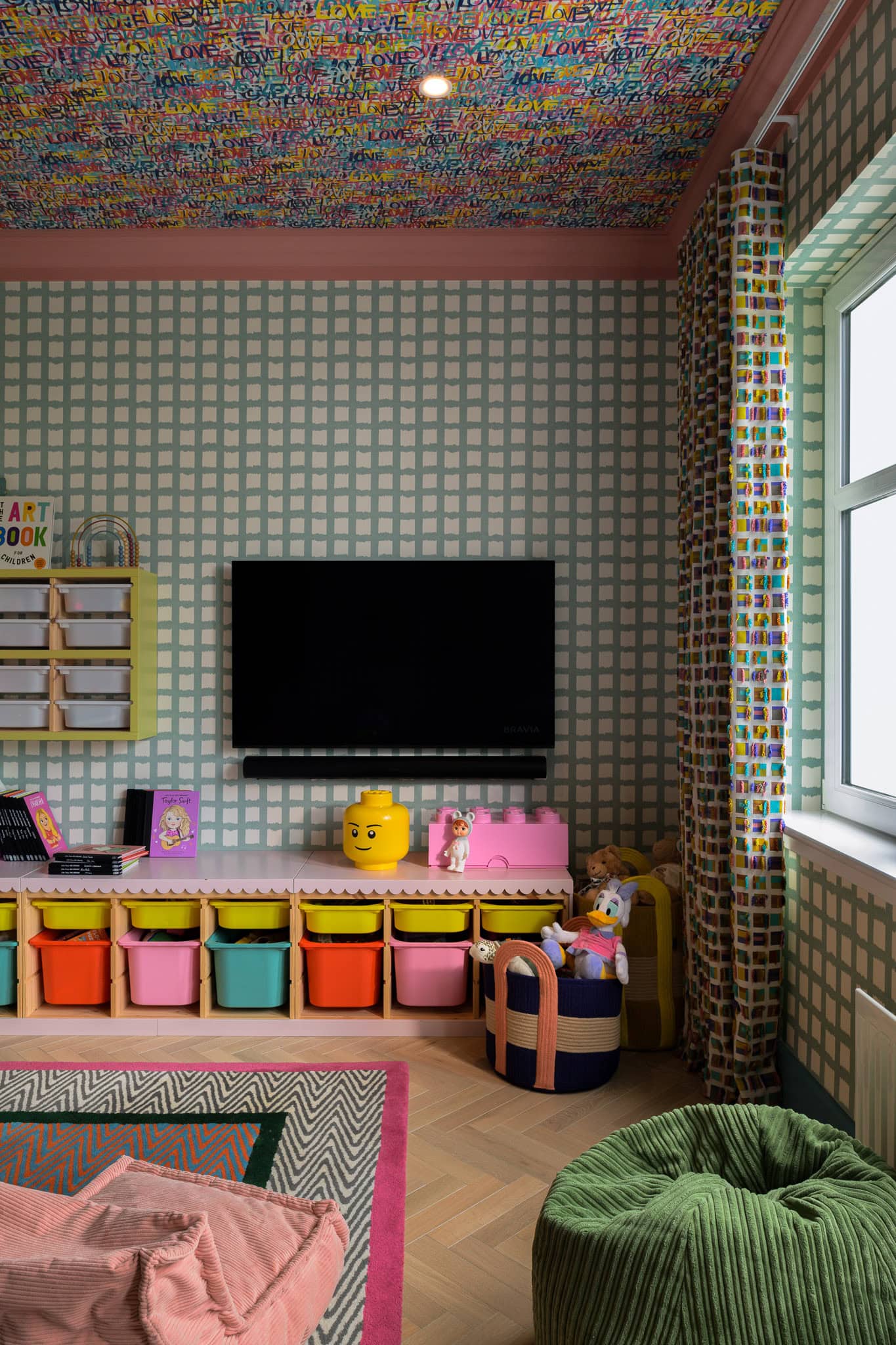 Colourful children's room with patterned walls, ceiling, and vibrant storage units.