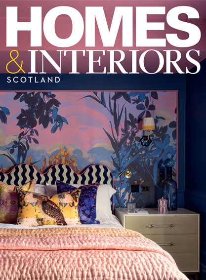 Interior shot of a colourful bedroom with a mural wall and decorative pillows.