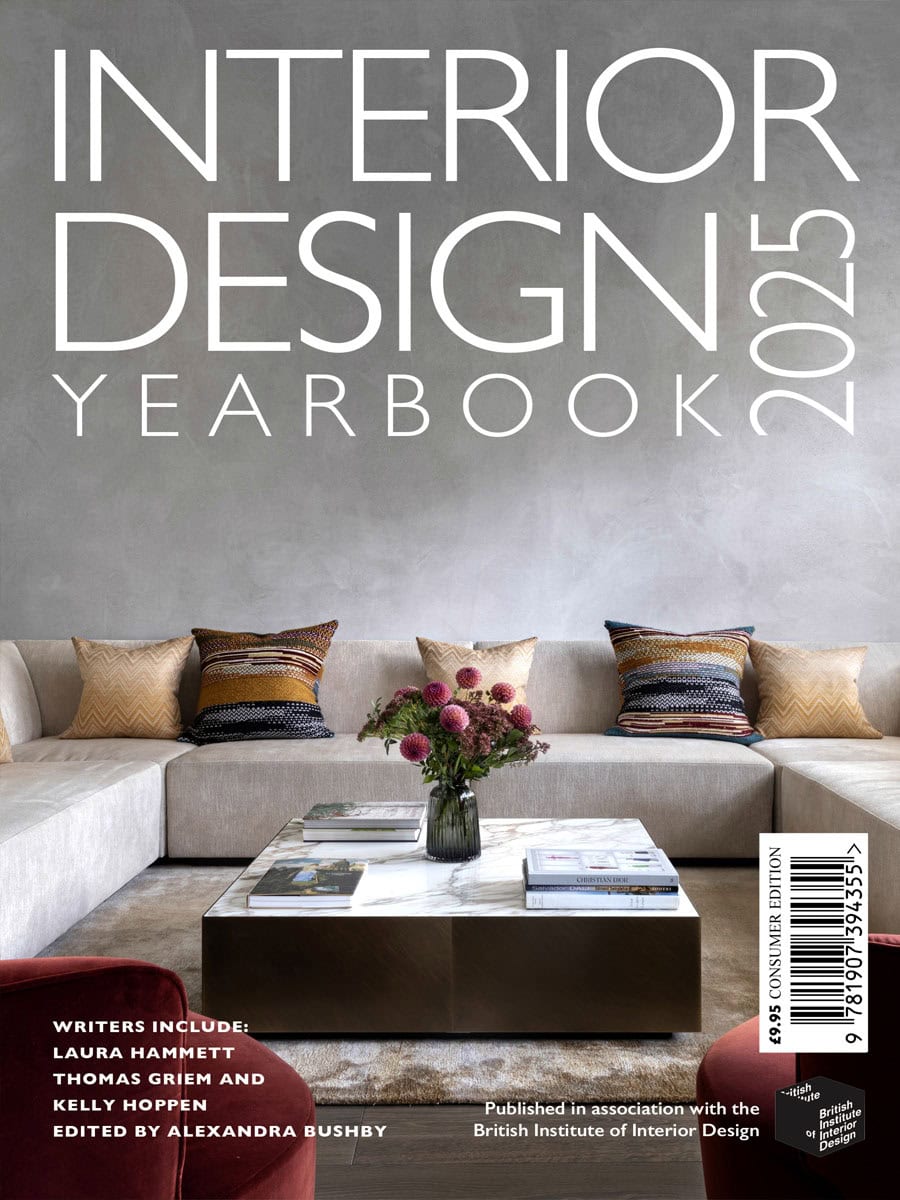 Interior design magazine cover with a modern living room scene and floral arrangement.