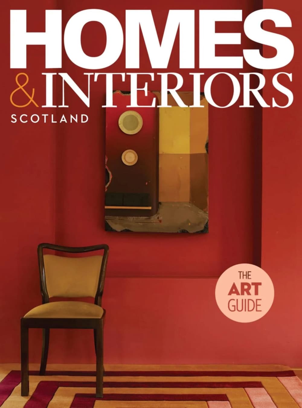 Interior shot of a red-walled room with a chair and artwork.