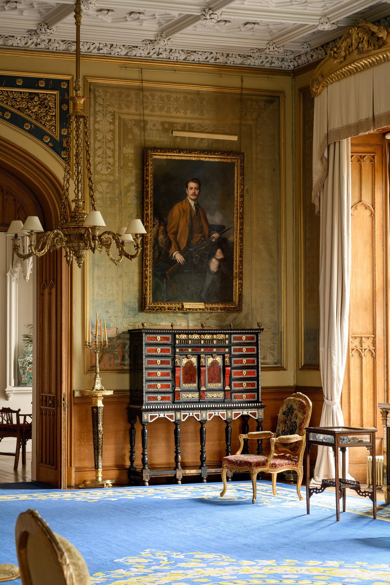 Elegant historic interior with ornate decor and classic furniture.