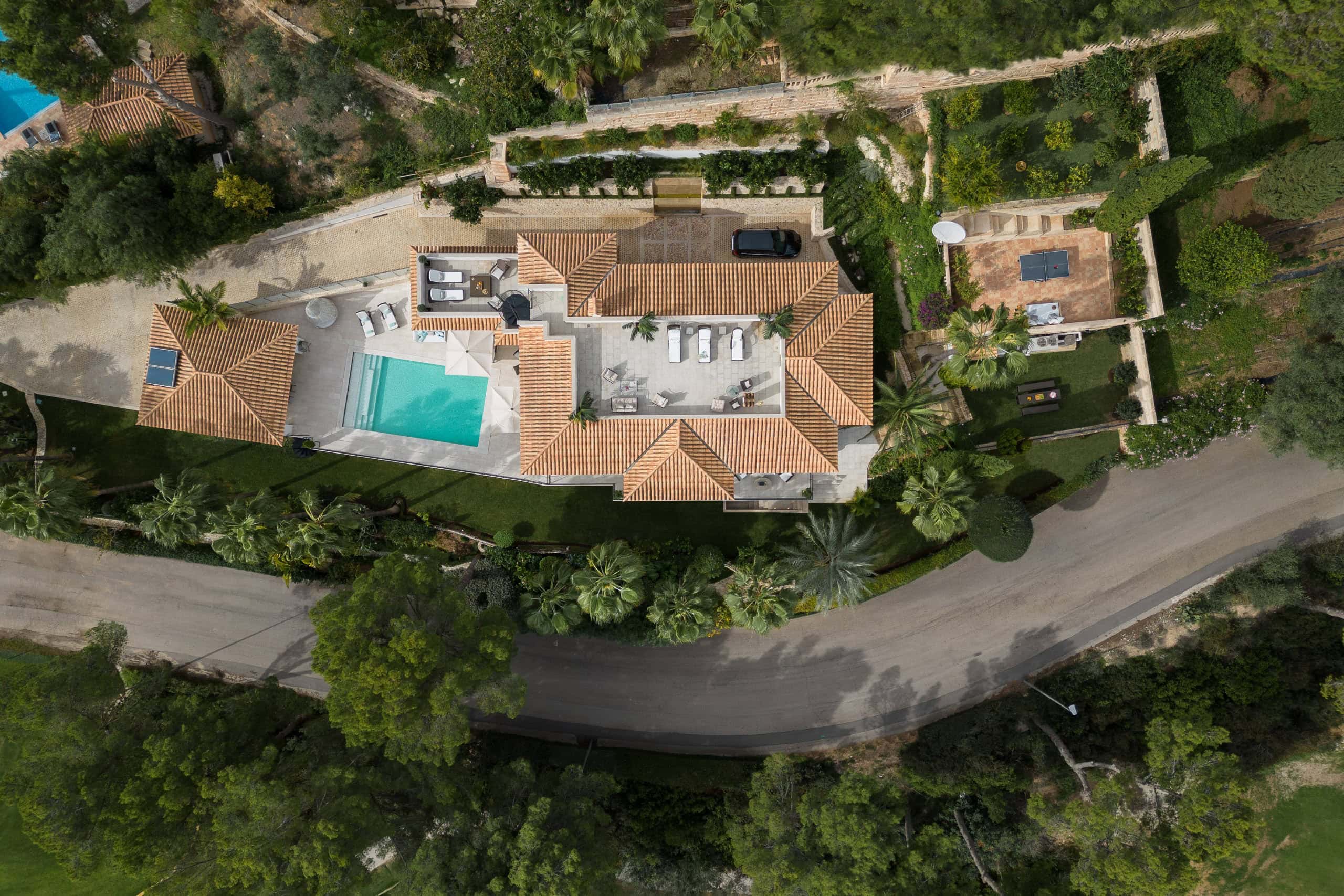 Luxury private residence with swimming pool and landscaped gardens, aerial view of modern architectu.
